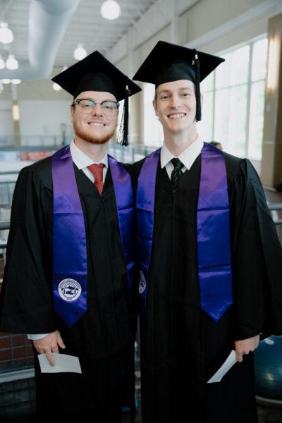 a couple of men in graduation gowns